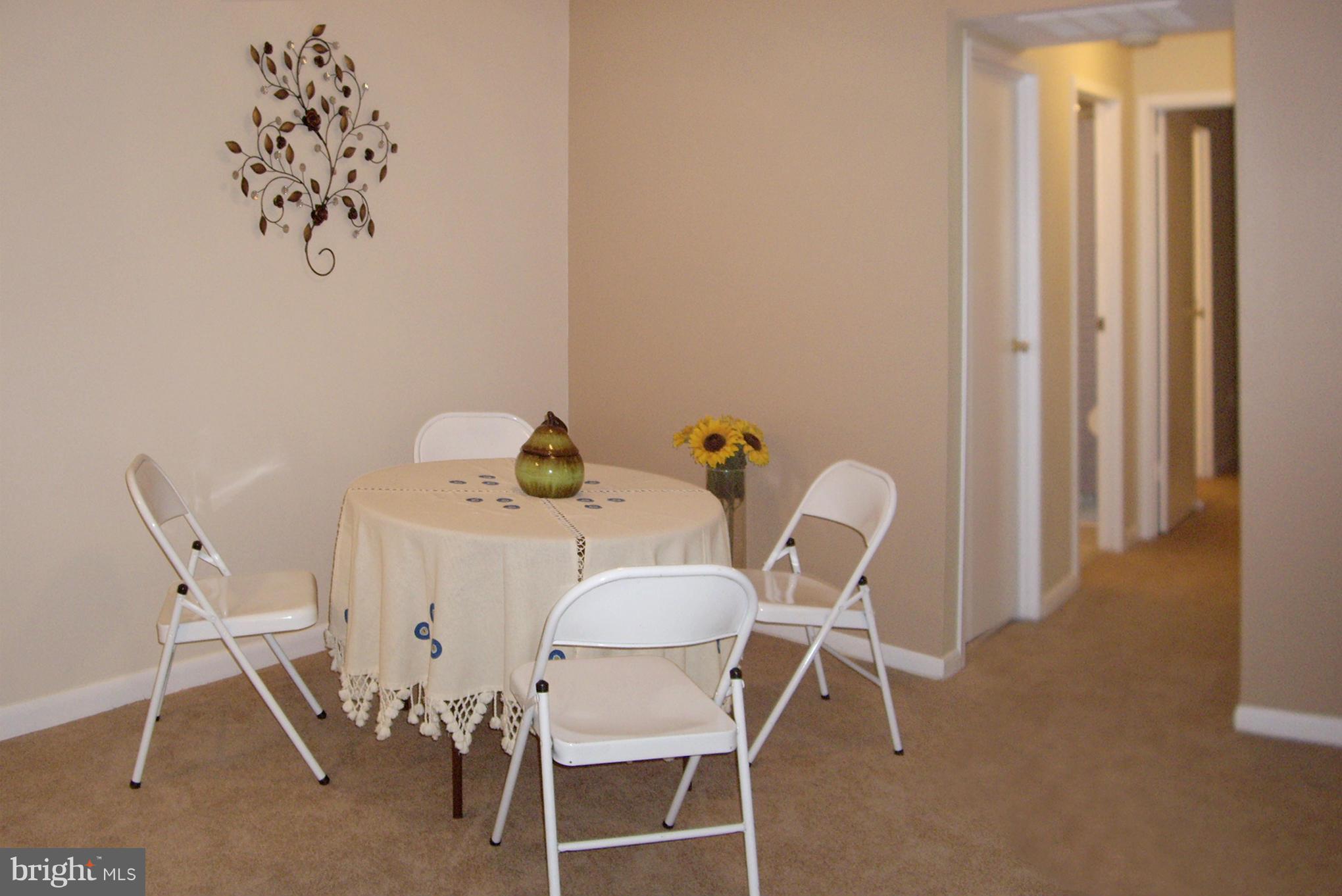 11212 Chestnut Grove Square, Unit 114 Reston, VA 20190 - Photo 8 of 18 a view of a dining room with furniture and wooden floor