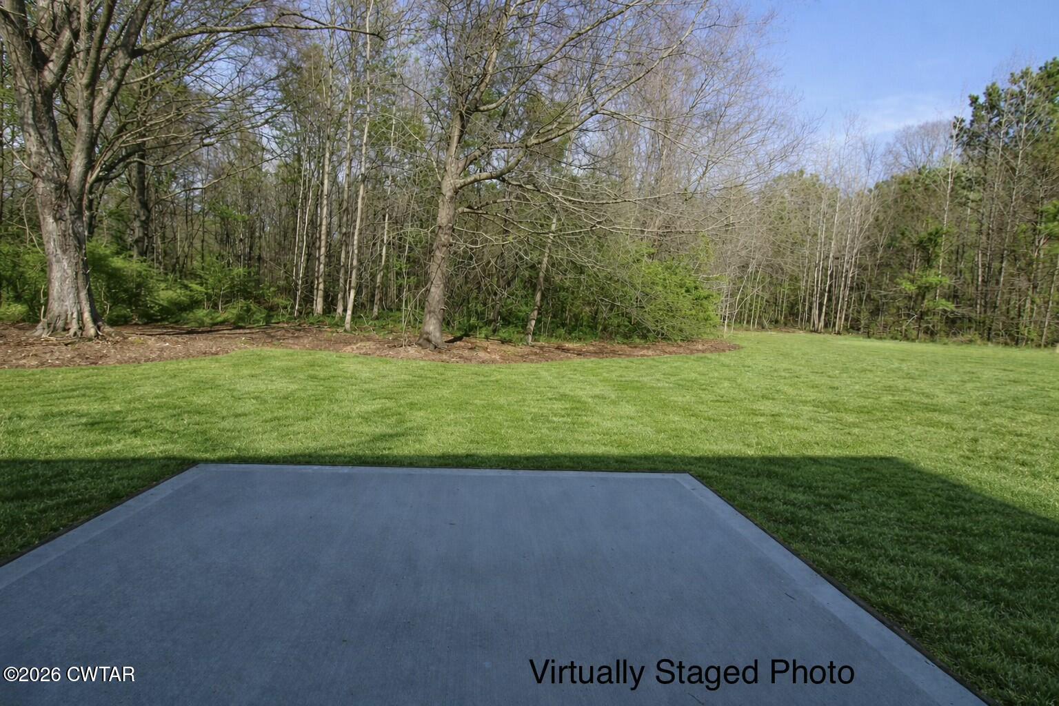 25 Weatherstone Drive Jackson, TN 38305 - Photo 13 of 15 a view of a grassy field with trees