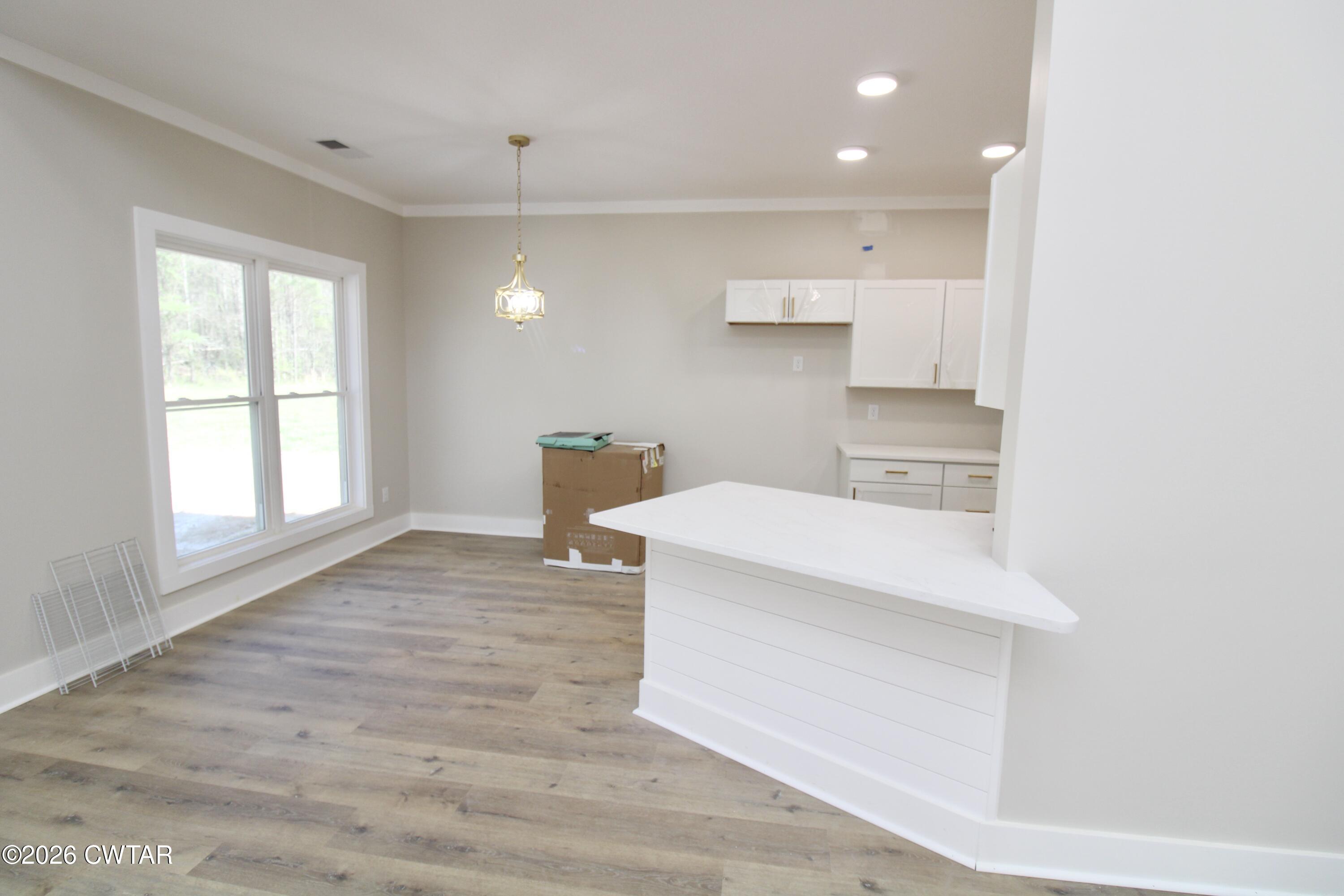 25 Weatherstone Drive Jackson, TN 38305 - Photo 4 of 15 a view of kitchen and empty room with wooden floor