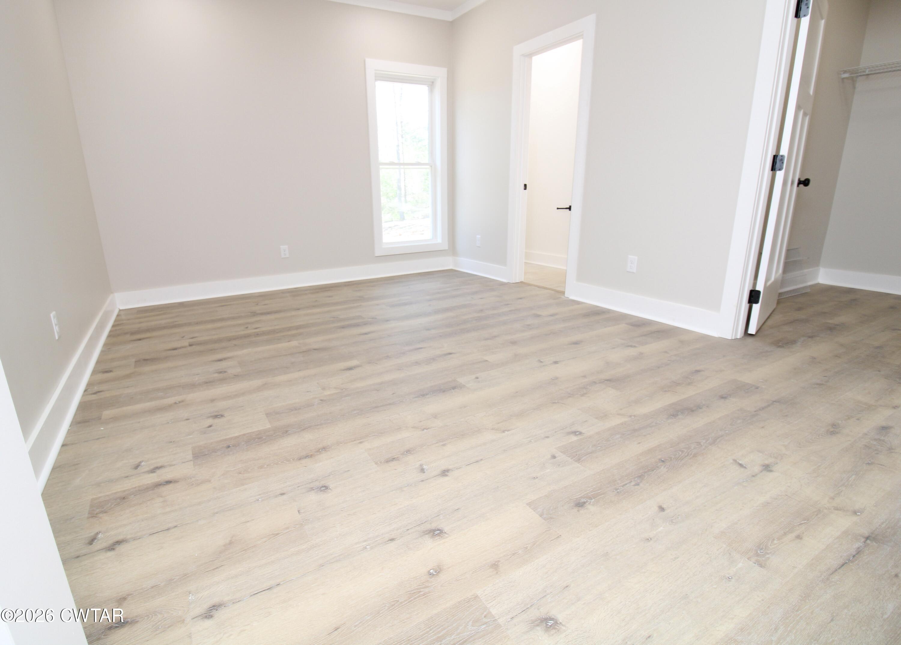 25 Weatherstone Drive Jackson, TN 38305 - Photo 6 of 15 an empty room with wooden floor and windows