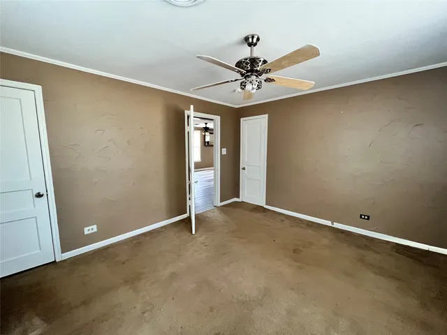 an empty room with a empty space and a ceiling fan