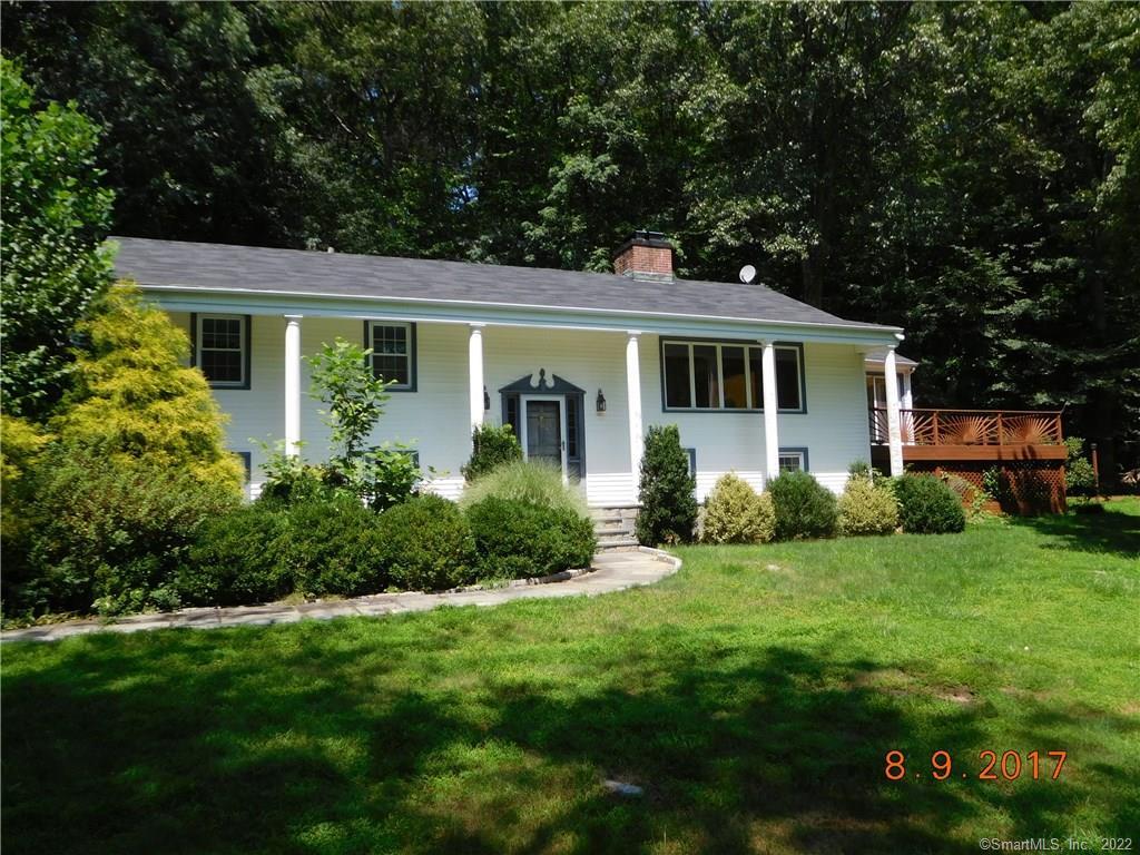 64 Little Brook Road Wilton, CT 06897 - Photo 1 of 1 a front view of house with yard and green space