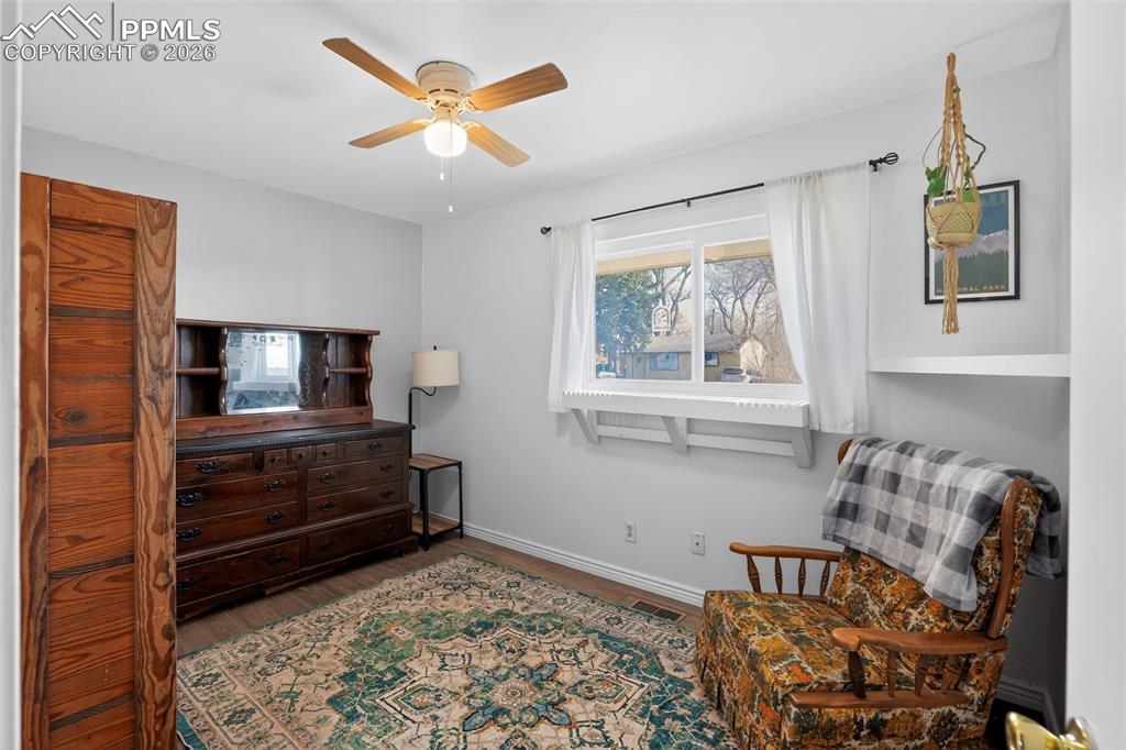 702 Erie Road Colorado Springs, CO 80910 - Photo 14 of 15 Living area featuring wood finished floors and a ceiling fan