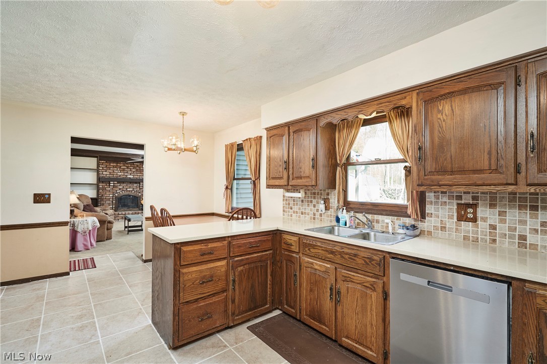 3097 Baughman Road Clinton, OH 44216 - Photo 5 of 27 Kitchen featuring warm wood cabinetry, light countertops, and a tiled backsplash