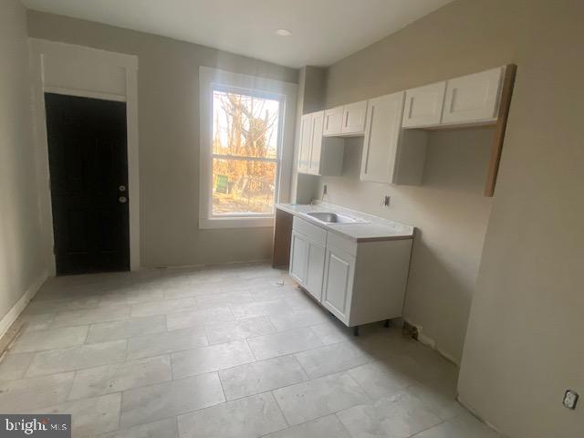 2730 Riggs Avenue Baltimore, MD 21216 - Photo 4 of 9 a view of a kitchen with a sink dishwasher and a refrigerator
