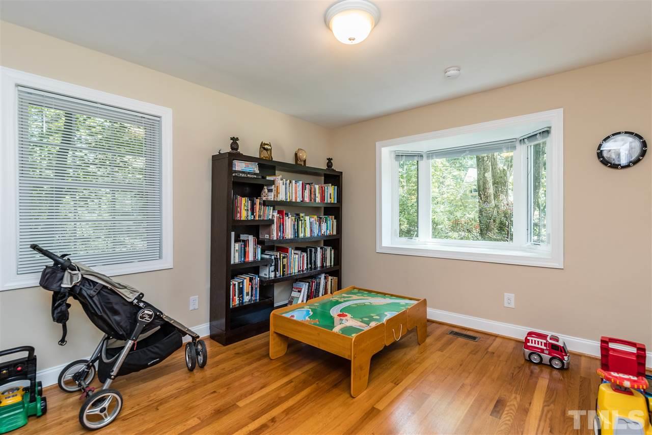 2808 Oberry Street Raleigh, NC 27607 - Photo 16 of 24 a living room with furniture and a book shelf