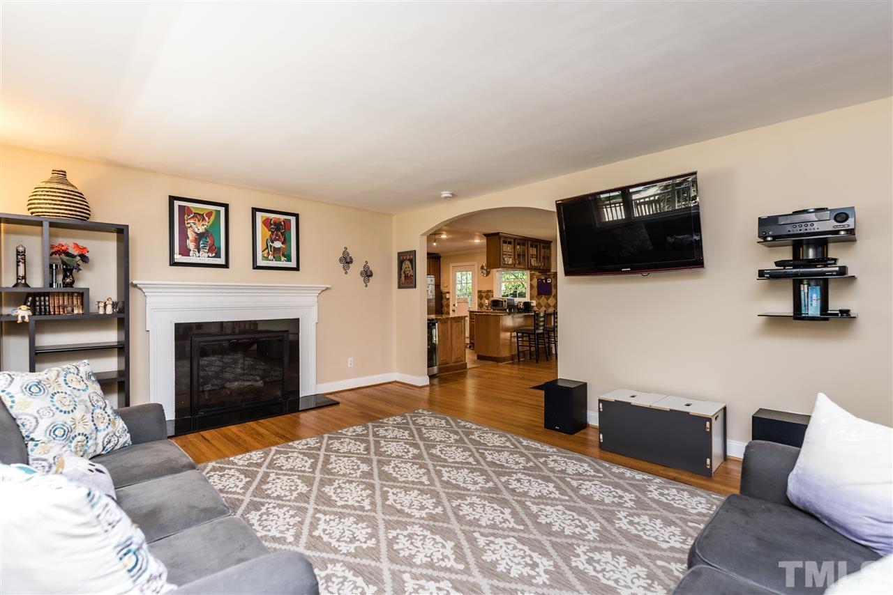 2808 Oberry Street Raleigh, NC 27607 - Photo 3 of 24 a living room with furniture a flat screen tv and a fireplace