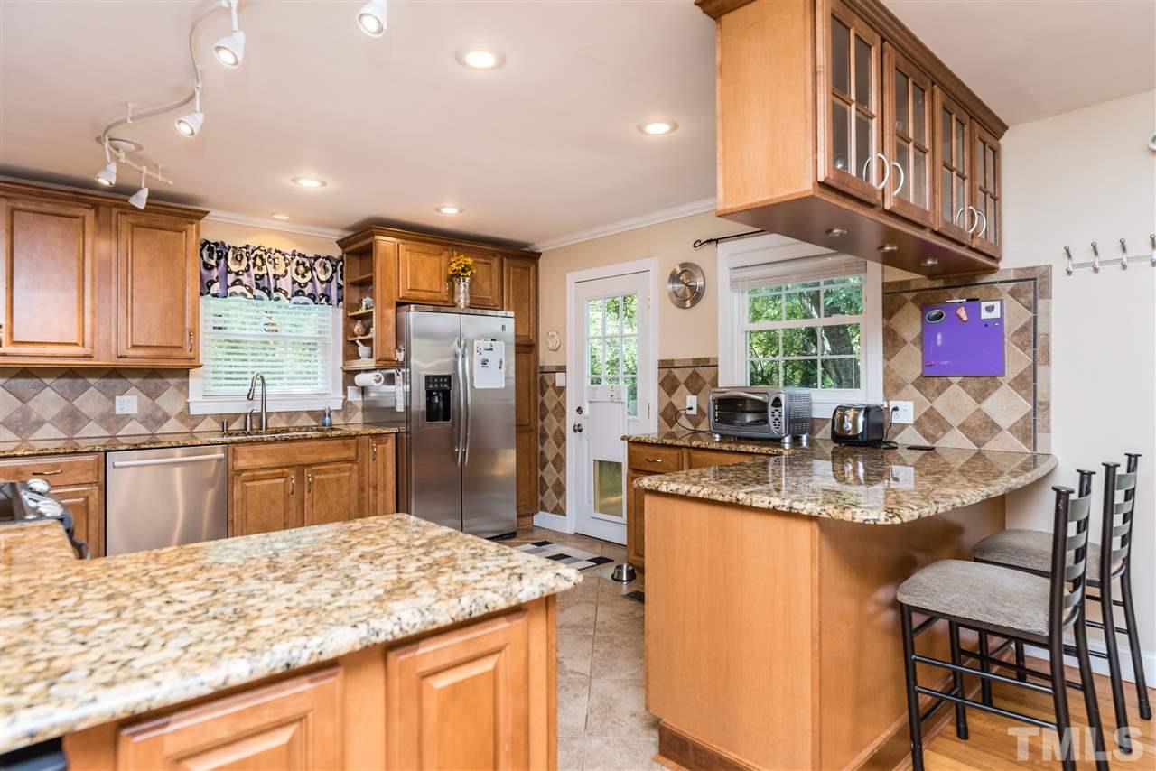 2808 Oberry Street Raleigh, NC 27607 - Photo 6 of 24 a kitchen with stainless steel appliances granite countertop a sink and a refrigerator