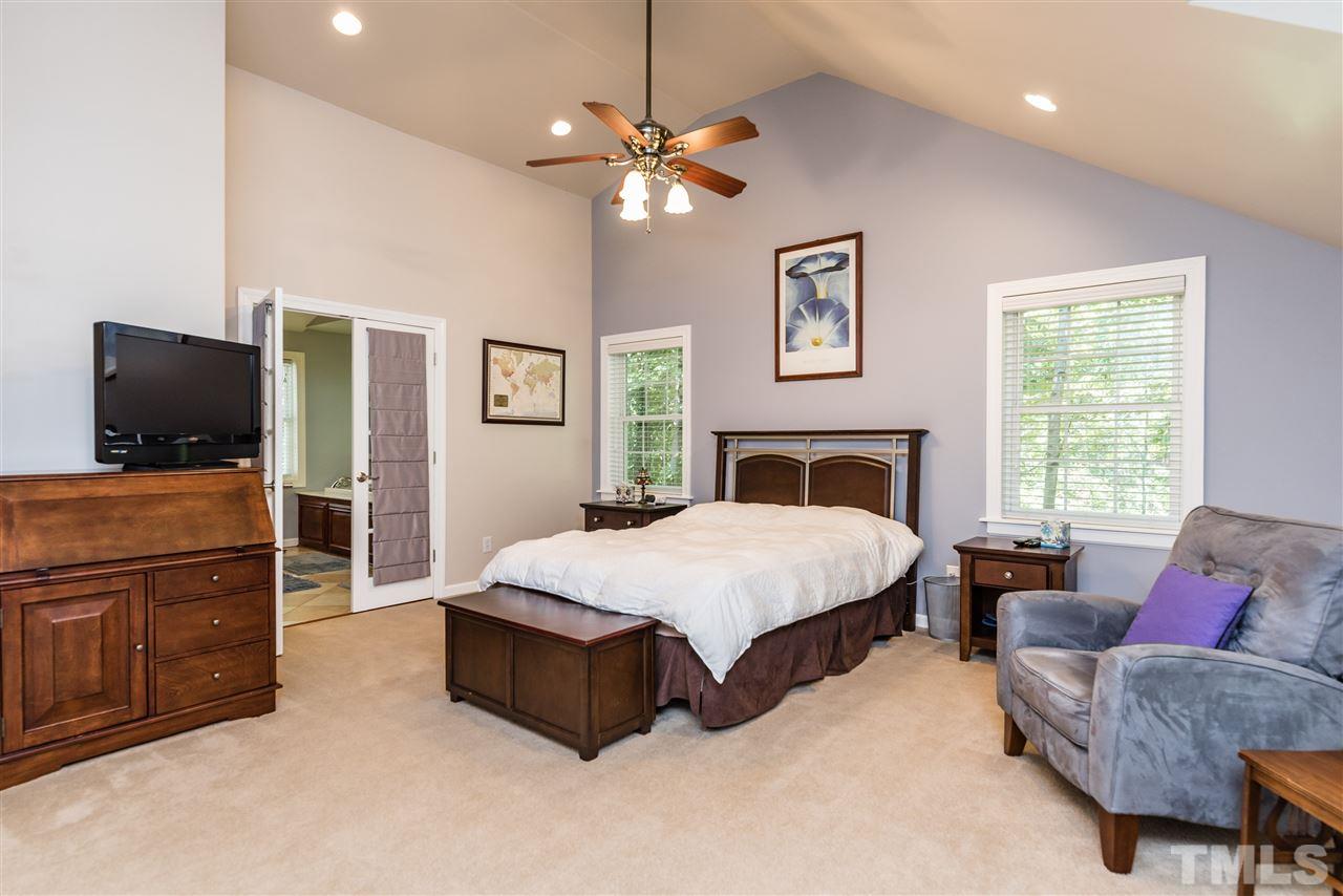 2808 Oberry Street Raleigh, NC 27607 - Photo 10 of 24 a spacious bedroom with a bed and a flat screen television
