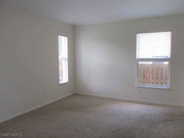 18359 Heather Road Fort Myers, FL 33967 - Photo 6 of 10 an empty room with windows