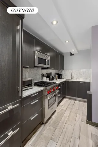 a kitchen with a table chairs sink and cabinets