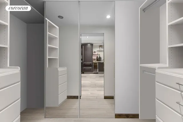 a bathroom with a sink a toilet a mirror and shower