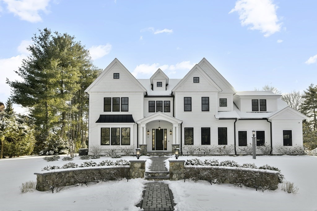 a front view of a residential houses with yard and trees