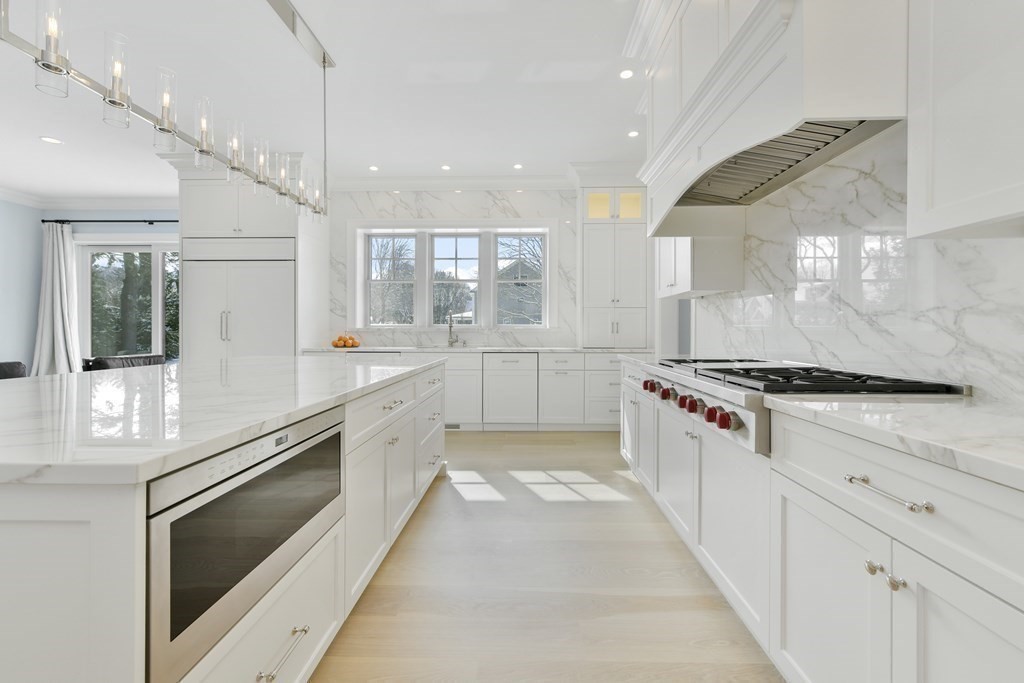 32 Burroughs Road Lexington, MA 02420 - Photo 3 of 38 a large white kitchen with stainless steel appliances granite countertop a stove and a sink