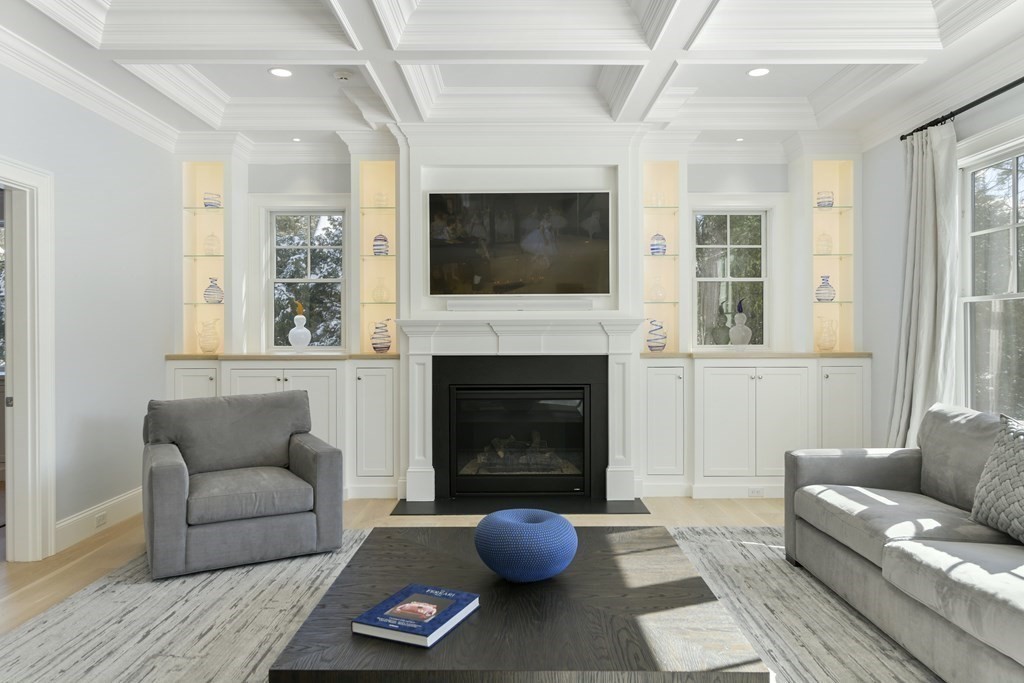 32 Burroughs Road Lexington, MA 02420 - Photo 8 of 38 a living room with furniture a flat screen tv and a fireplace