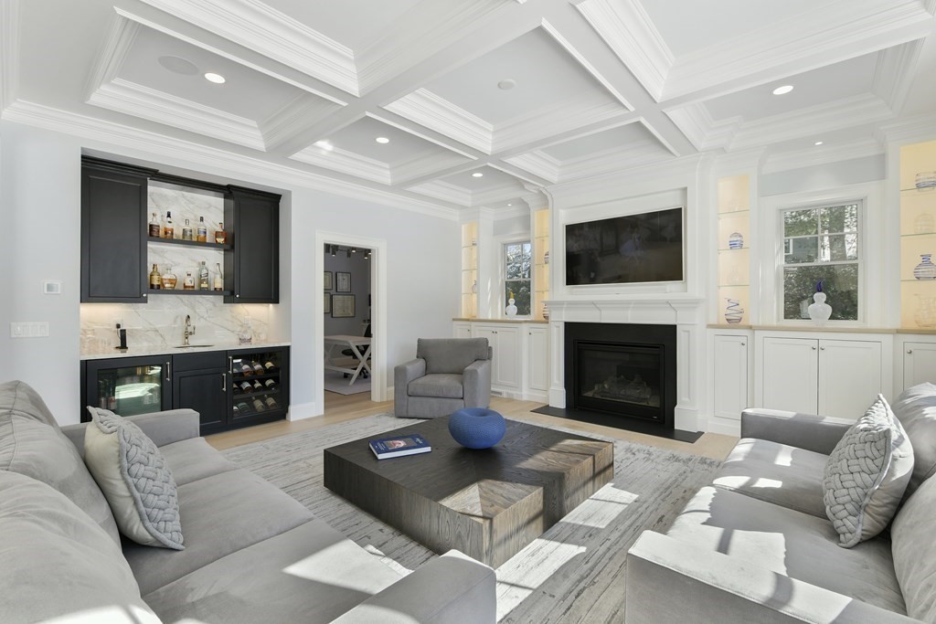 32 Burroughs Road Lexington, MA 02420 - Photo 10 of 38 a living room with furniture a flat screen tv and a fireplace