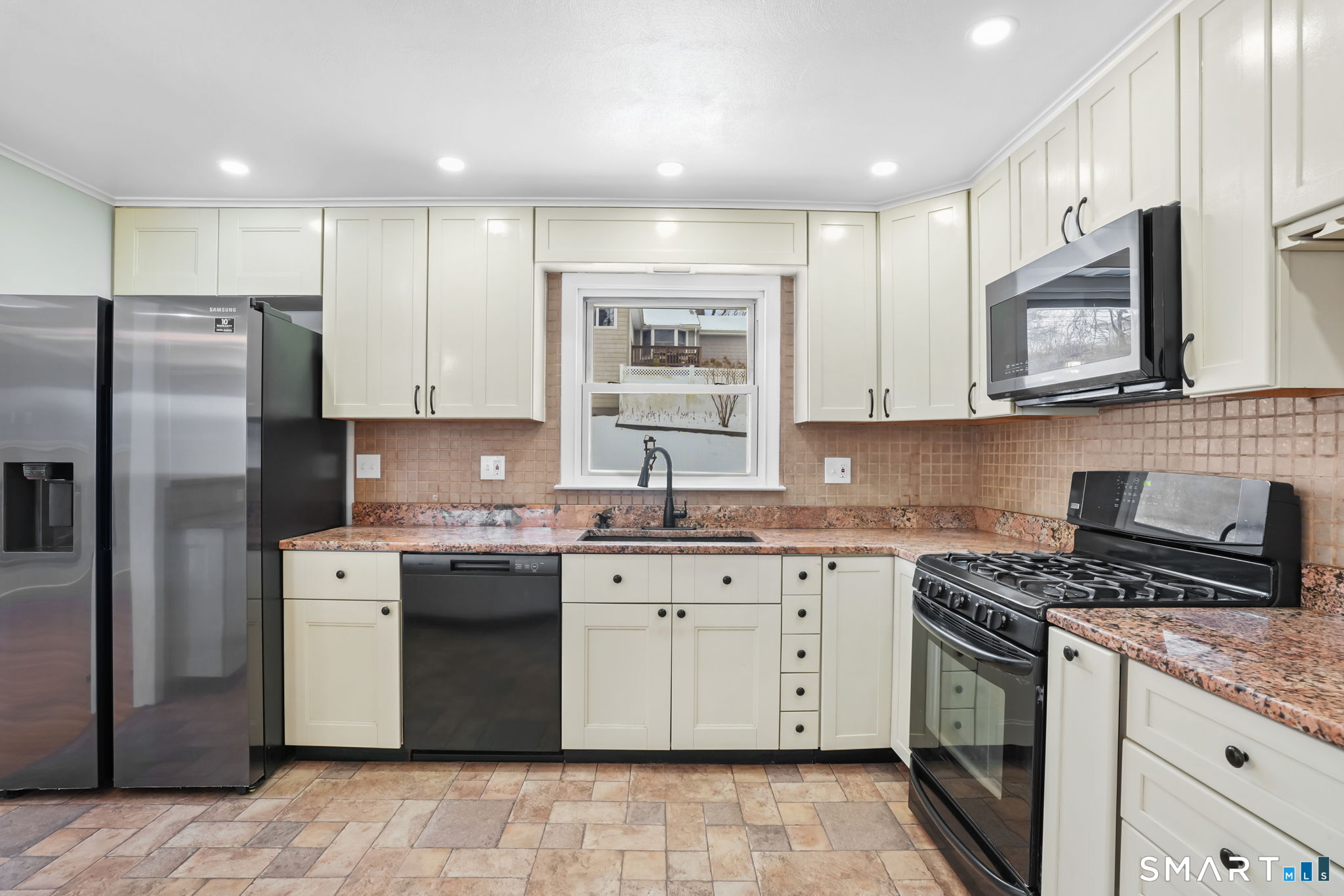 25 Fairchild Road Stratford, CT 06614 - Photo 12 of 40 a kitchen with stainless steel appliances granite countertop a stove a sink dishwasher a refrigerator and a microwave