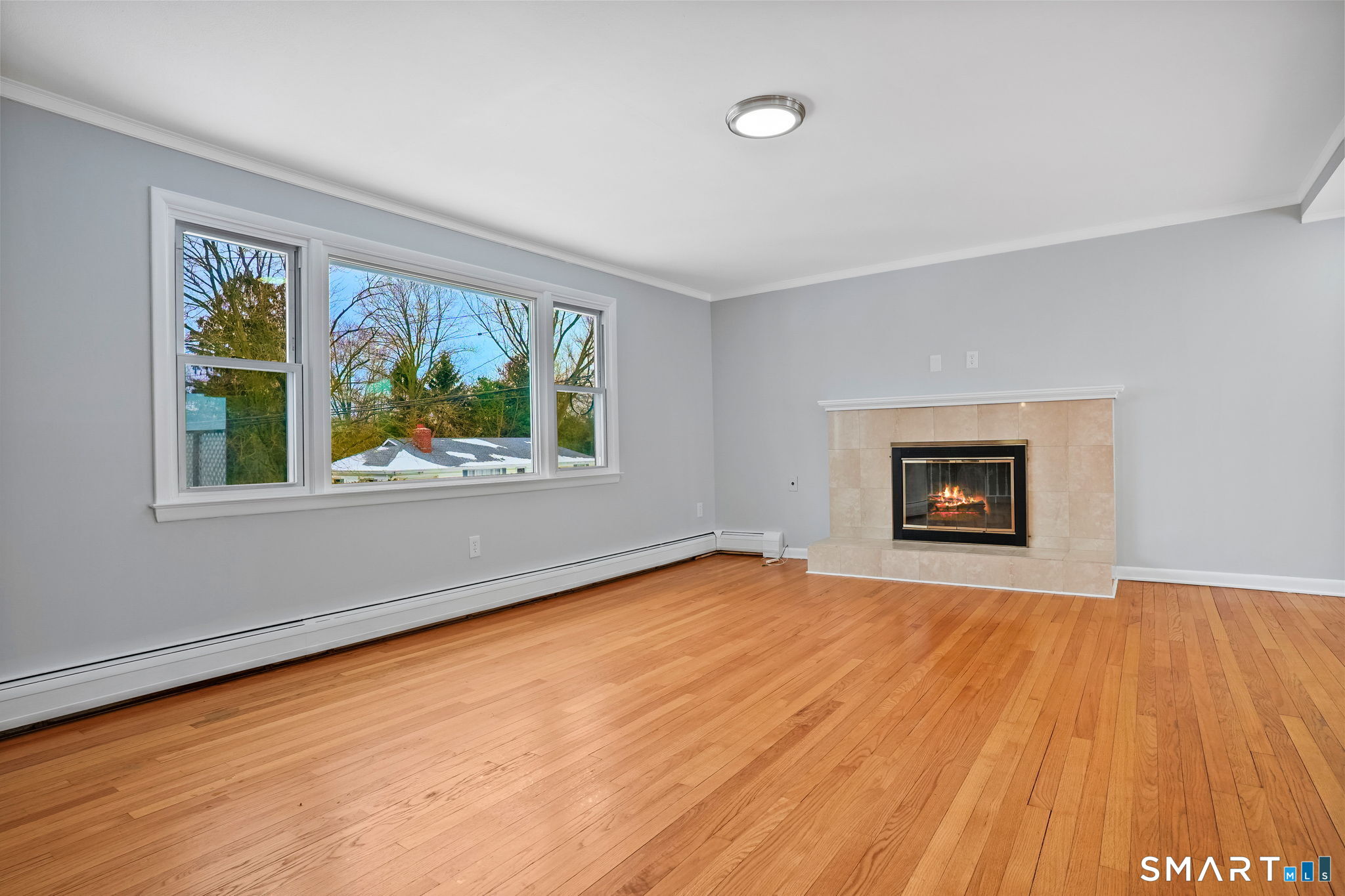 25 Fairchild Road Stratford, CT 06614 - Photo 3 of 40 a view of an empty room with wooden floor and a window