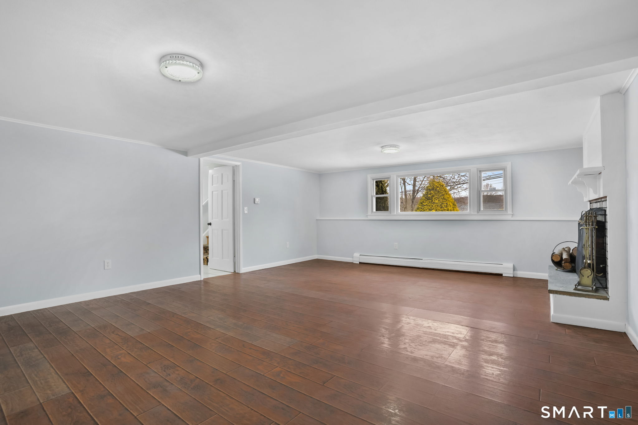 25 Fairchild Road Stratford, CT 06614 - Photo 31 of 40 a view of an empty room with a window and wooden floor