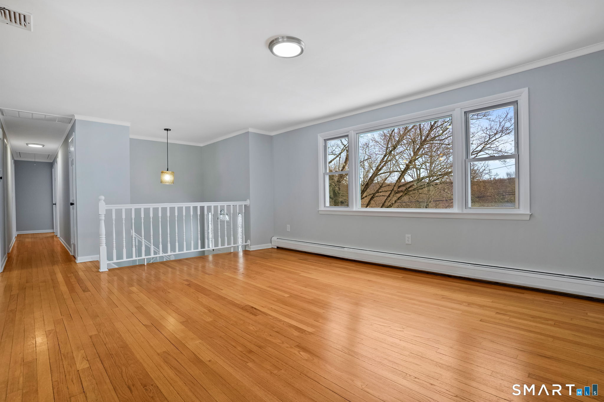 25 Fairchild Road Stratford, CT 06614 - Photo 4 of 40 an empty room with wooden floor and windows