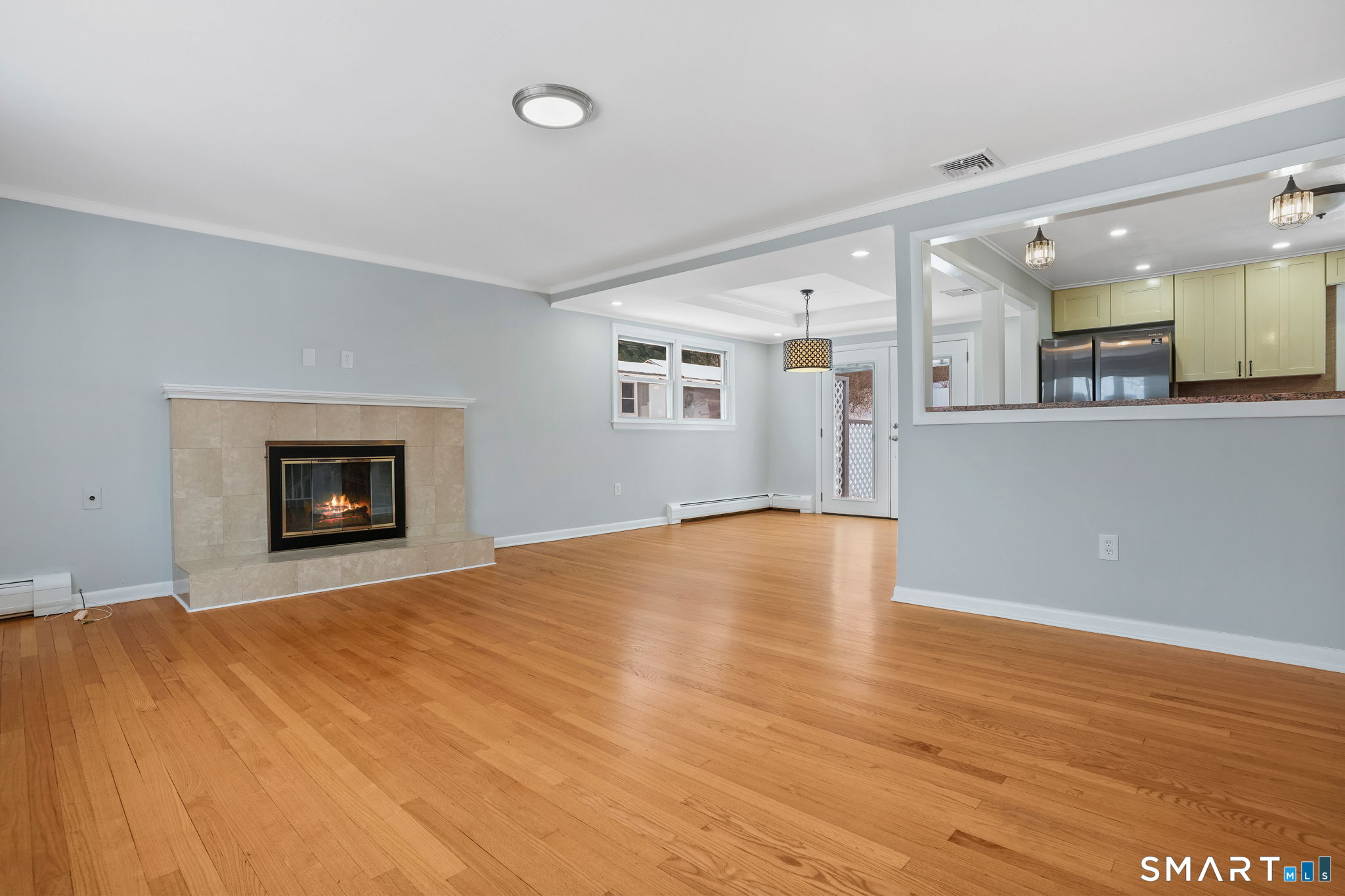 25 Fairchild Road Stratford, CT 06614 - Photo 6 of 40 a view of an empty room with wooden floor and a window