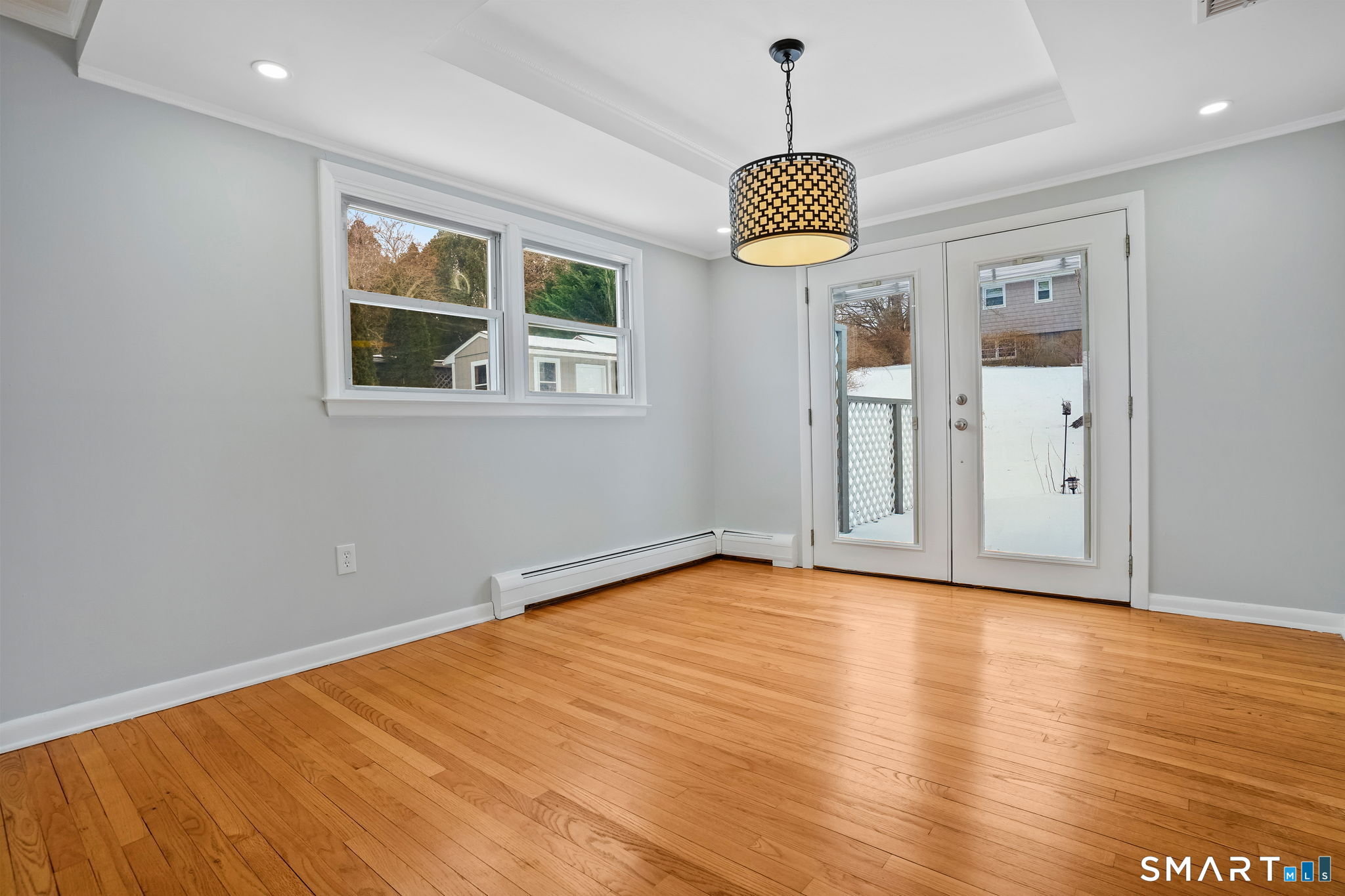 25 Fairchild Road Stratford, CT 06614 - Photo 7 of 40 a view of an empty room with wooden floor and windows