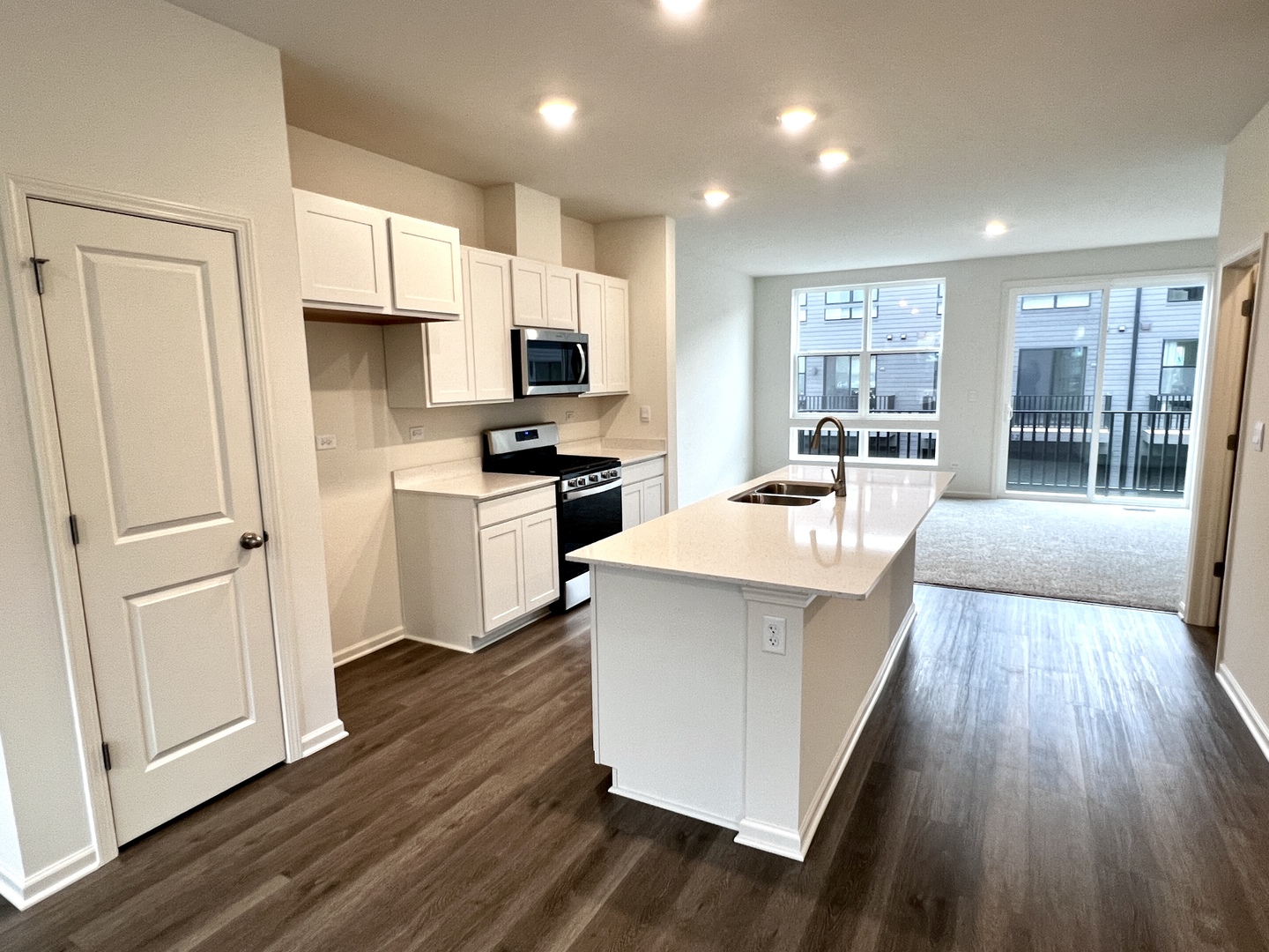 375 Summit Circle Lombard, IL 60148 - Photo 5 of 49 a white kitchen with wooden floor and stainless steel appliances