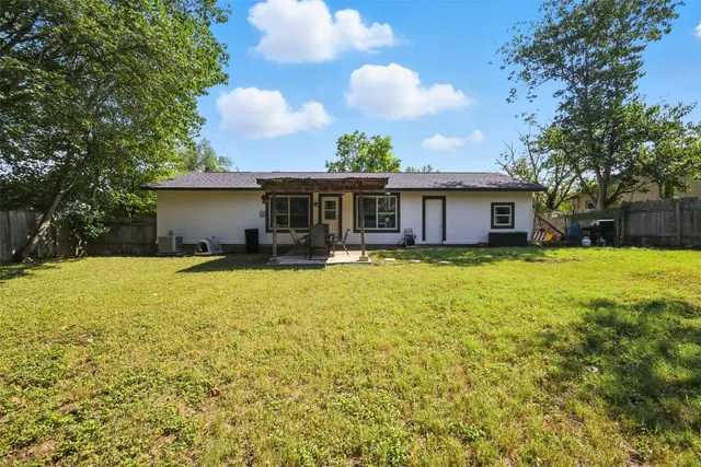 a view of a patio with a table chairs and a backyard