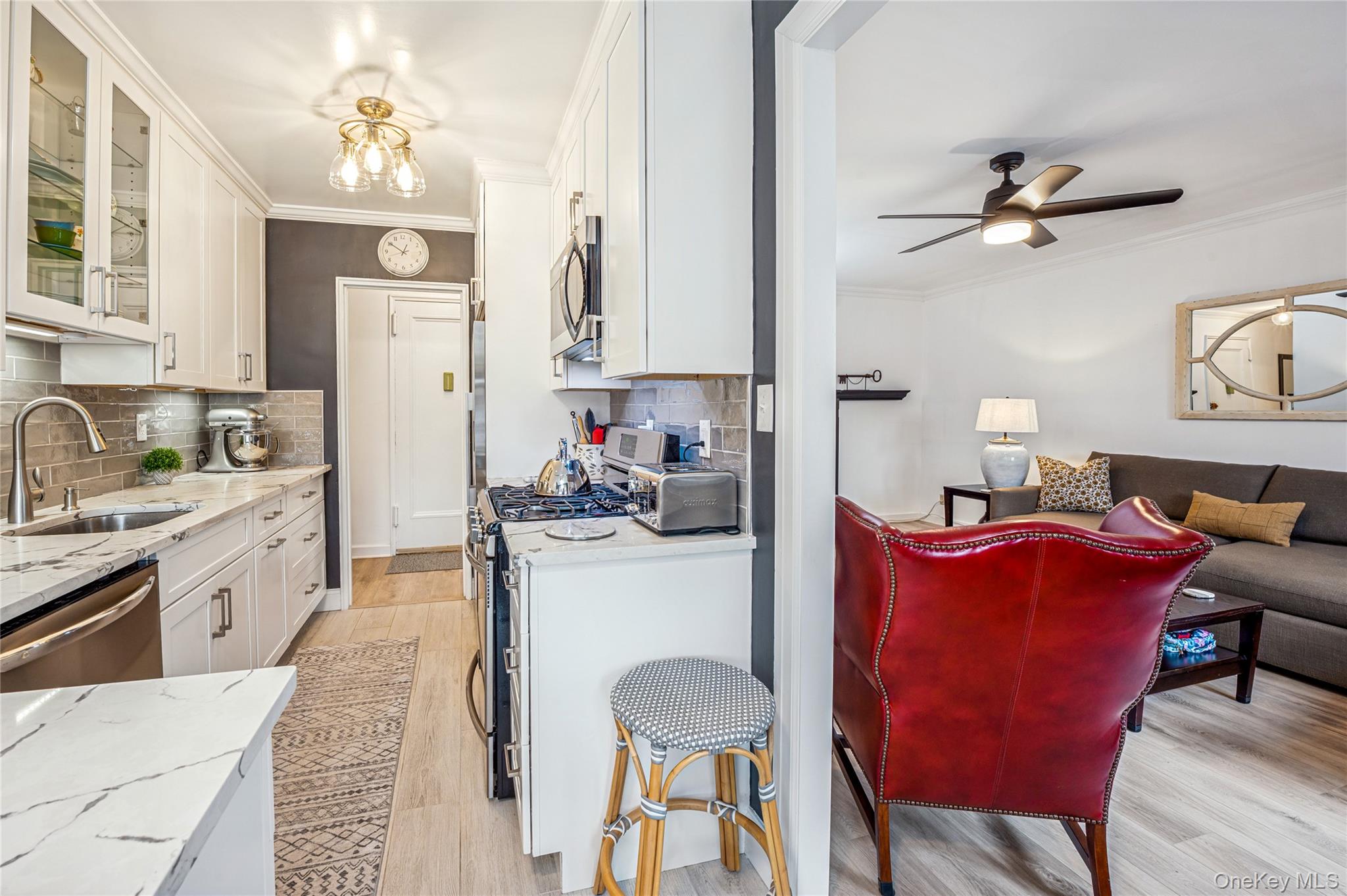 781 Palmer Road, Unit 4F Bronxville, NY 10708 - Photo 7 of 18 a kitchen with stainless steel appliances granite countertop a dining table chairs stove a sink and dishwasher