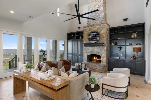 a living room filled with furniture and a large window