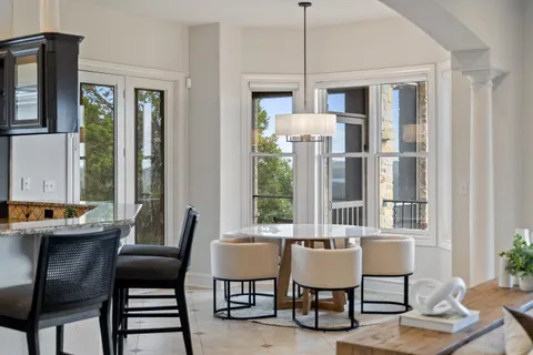 a kitchen with granite countertop kitchen island stainless steel appliances a sink stove and cabinets