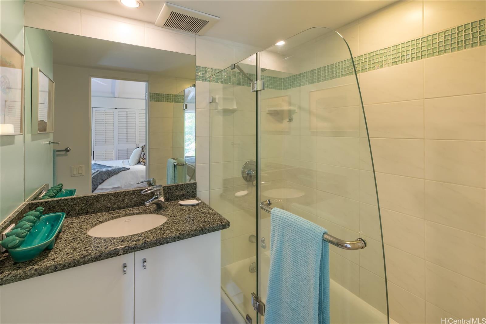 445 Kawailoa Road, Unit 4 Kailua, HI 96734 - Photo 13 of 23 a bathroom with a shower sink vanity granite and mirror