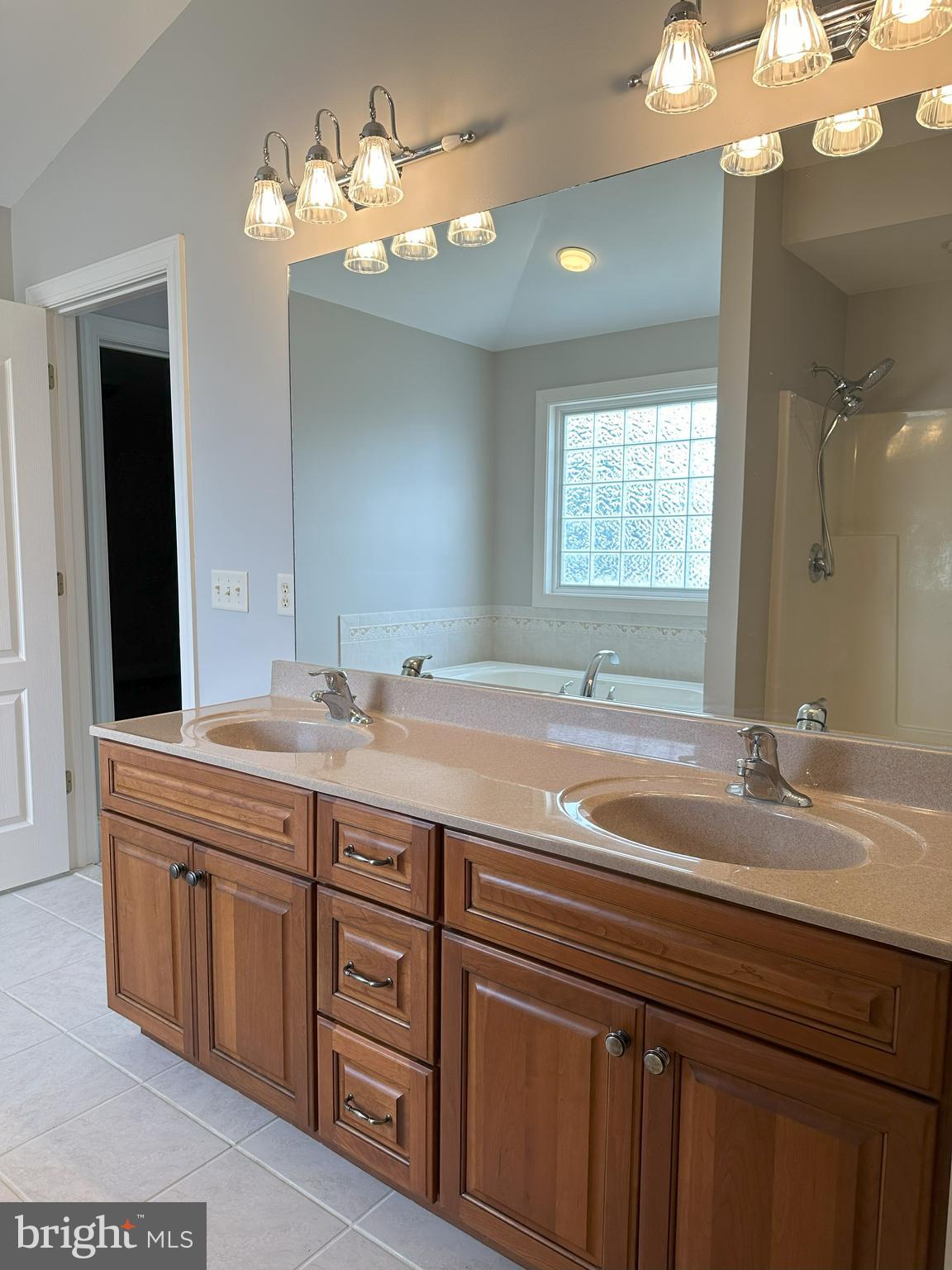 564 Brookfield Drive Dover, DE 19901 - Photo 21 of 25 a bathroom with a granite countertop sink a large mirror and a light fixture