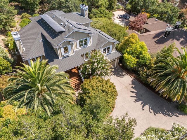 an aerial view of a house with a yard