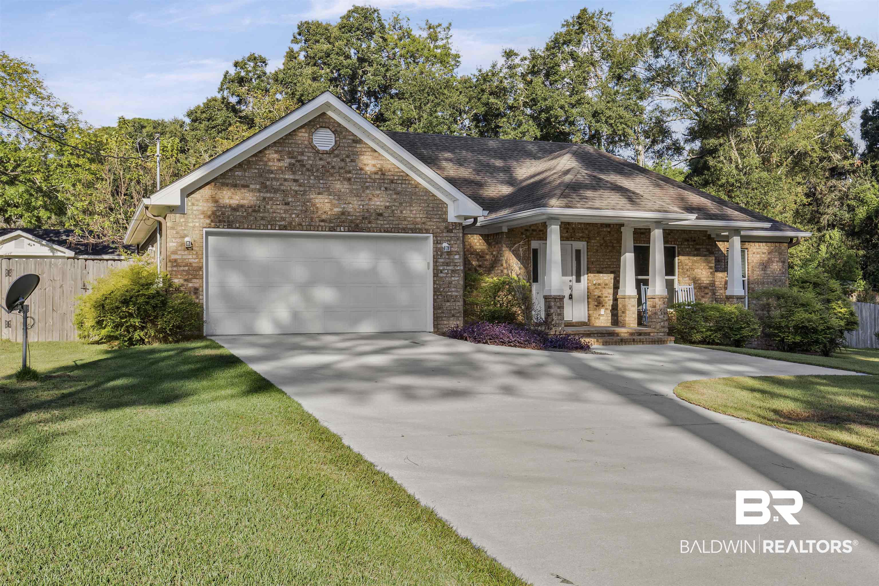 30851 Joseph Drive Spanish Fort, AL 36527 - Photo 2 of 22 View of front of house with covered porch, concrete driveway, brick siding, and an attached garage