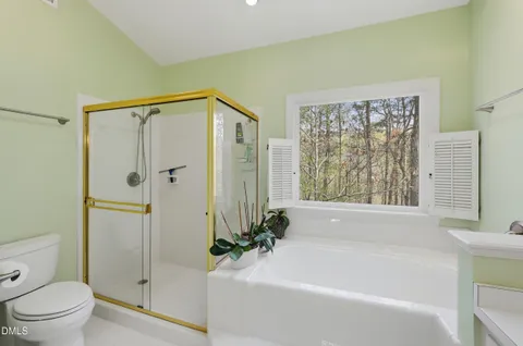 a white bath tub sitting next to a toilet