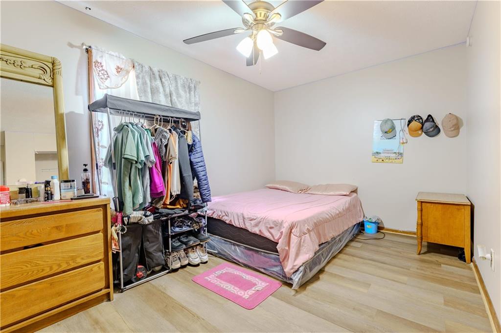 6543 Sage Street Atlanta, GA 30340 - Photo 11 of 18 a bedroom with bed and a chandelier