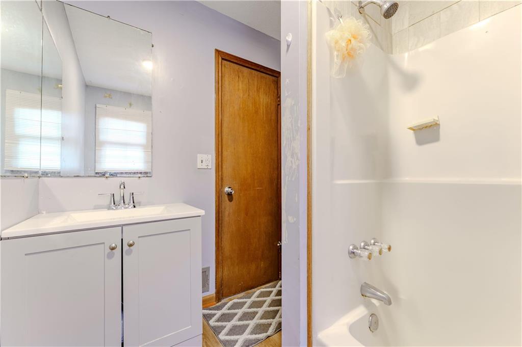 6543 Sage Street Atlanta, GA 30340 - Photo 16 of 18 a bathroom with a sink a toilet and shower