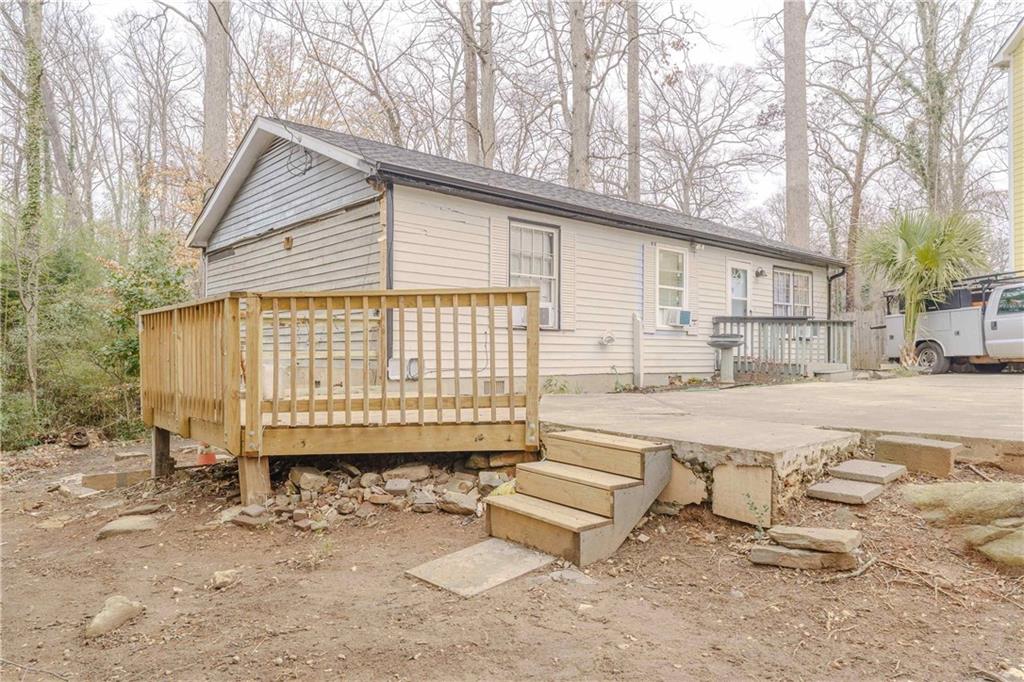 6543 Sage Street Atlanta, GA 30340 - Photo 2 of 18 a white house that has a bench and trees in it