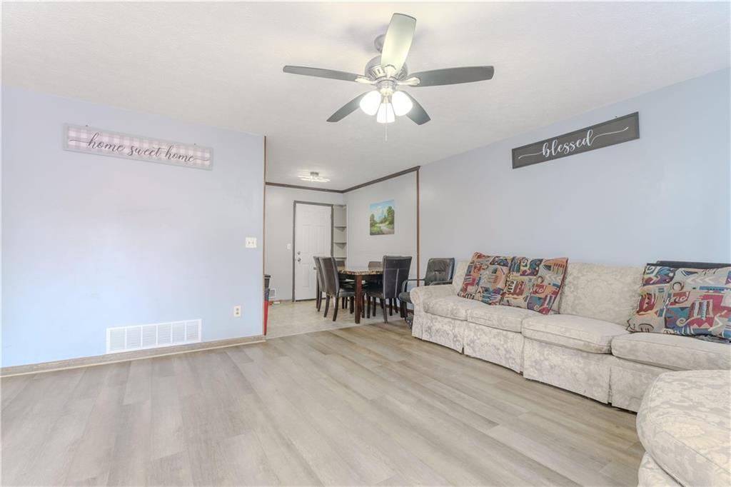 6543 Sage Street Atlanta, GA 30340 - Photo 3 of 18 a living room with furniture and a chandelier