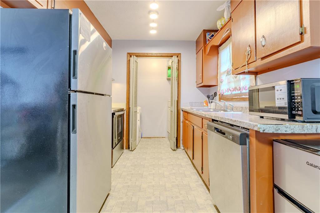 6543 Sage Street Atlanta, GA 30340 - Photo 6 of 18 a kitchen with stainless steel appliances granite countertop a refrigerator and a sink