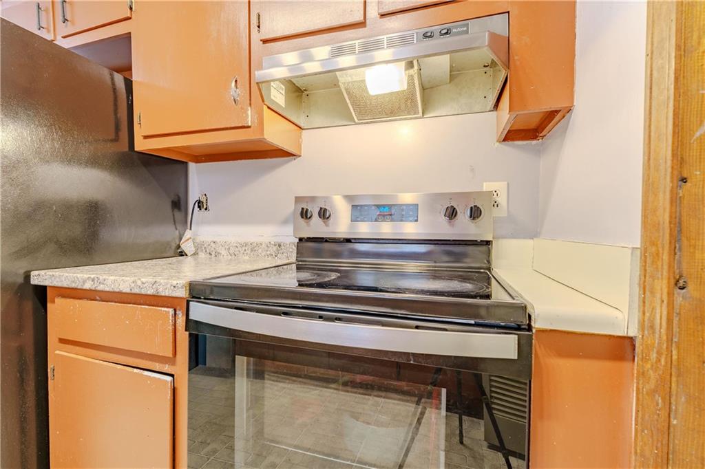 6543 Sage Street Atlanta, GA 30340 - Photo 7 of 18 a kitchen with a stove and a microwave