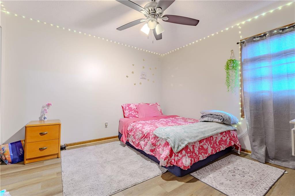 6543 Sage Street Atlanta, GA 30340 - Photo 9 of 18 a bedroom with a bed and a chandelier