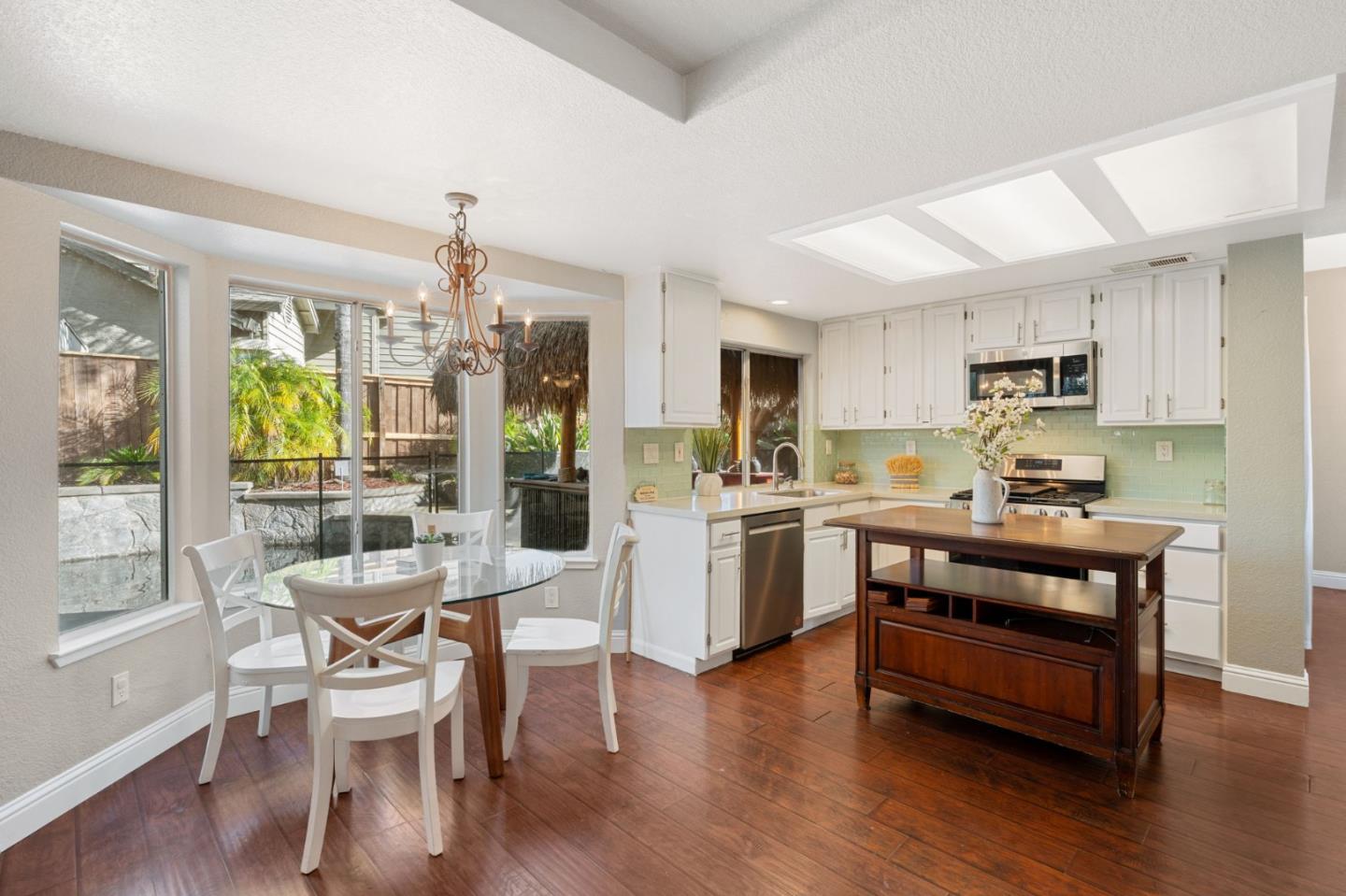 3335 Sandalwood Road Rocklin, CA 95765 - Photo 12 of 30 a kitchen with a refrigerator a stove top oven a sink dishwasher with a dining table and chairs