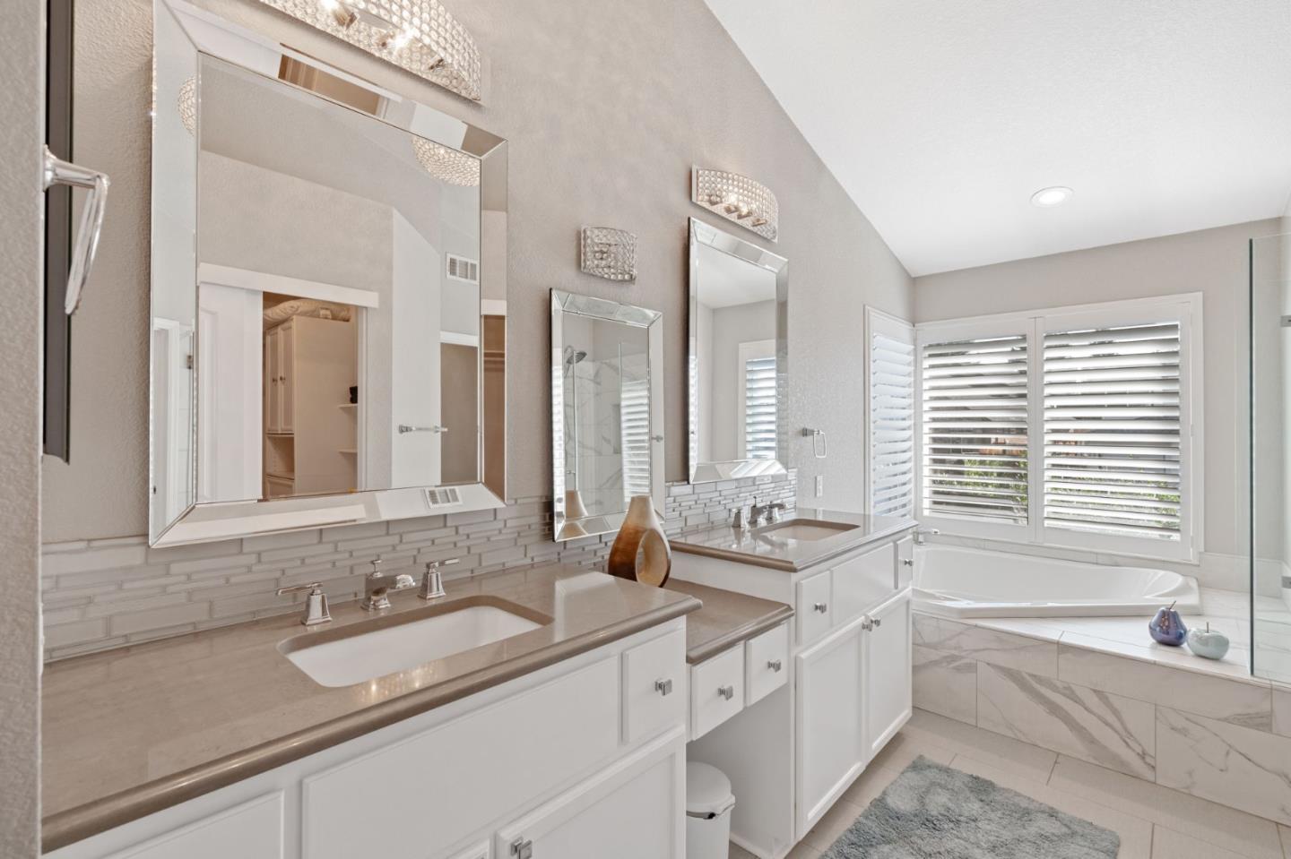 3335 Sandalwood Road Rocklin, CA 95765 - Photo 16 of 30 a bathroom with double vanity sinks a mirror and a bathtub
