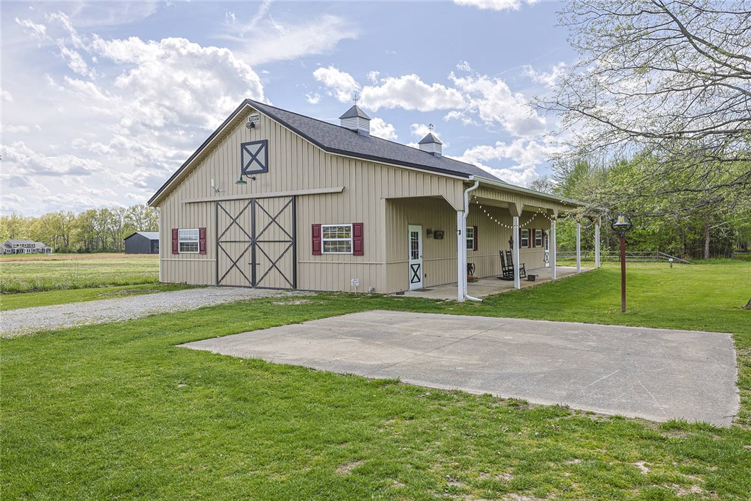 1757 Phillips Road Lebanon, OH 45036 - Photo 35 of 51 This expansive barn structure offers ample space and a charming covered porch, ideal for various rural pursuits.