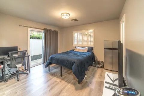 a spacious bedroom with a bed and a table in it