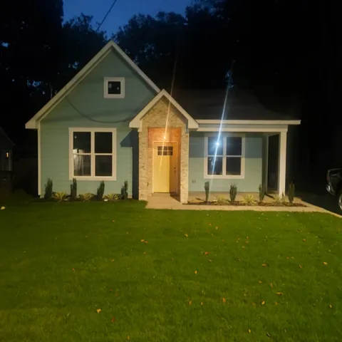 front view of a house with a yard