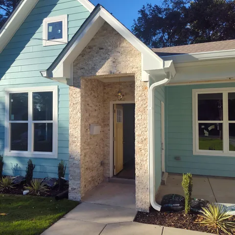 a front view of a house with a garden