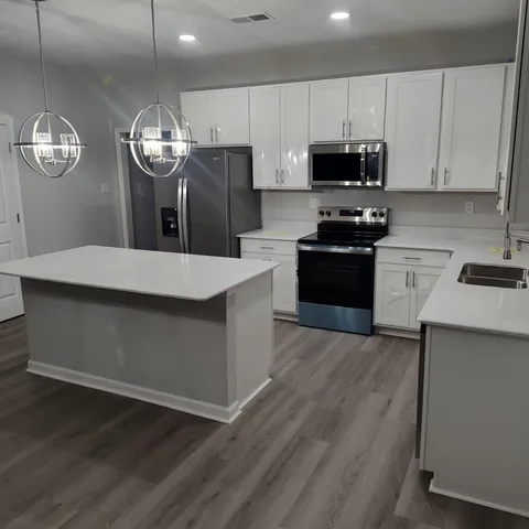 a view of a kitchen counter space a sink and dishwasher